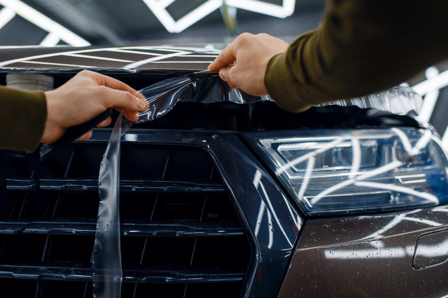 worker-cuts-protection-film-on-car-hood-2024-11-27-03-30-09-utc-1-.jpg